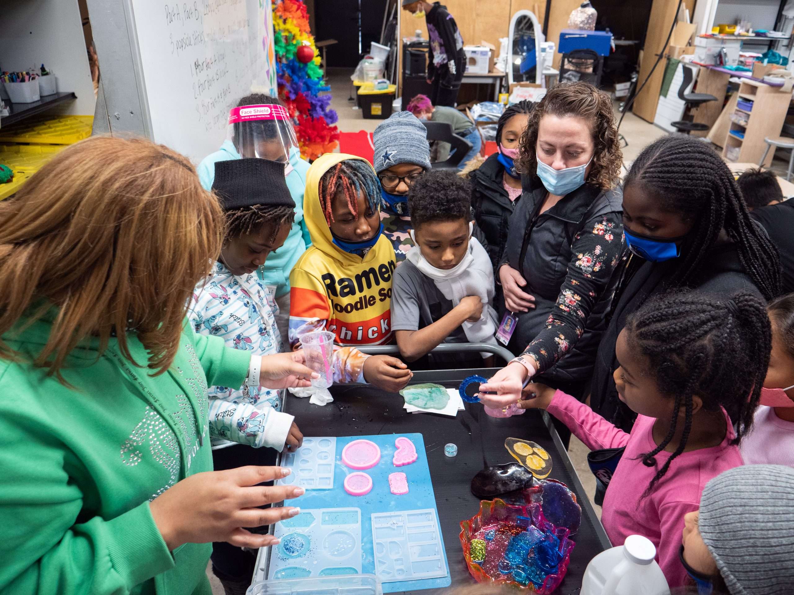 students and teacher using resin