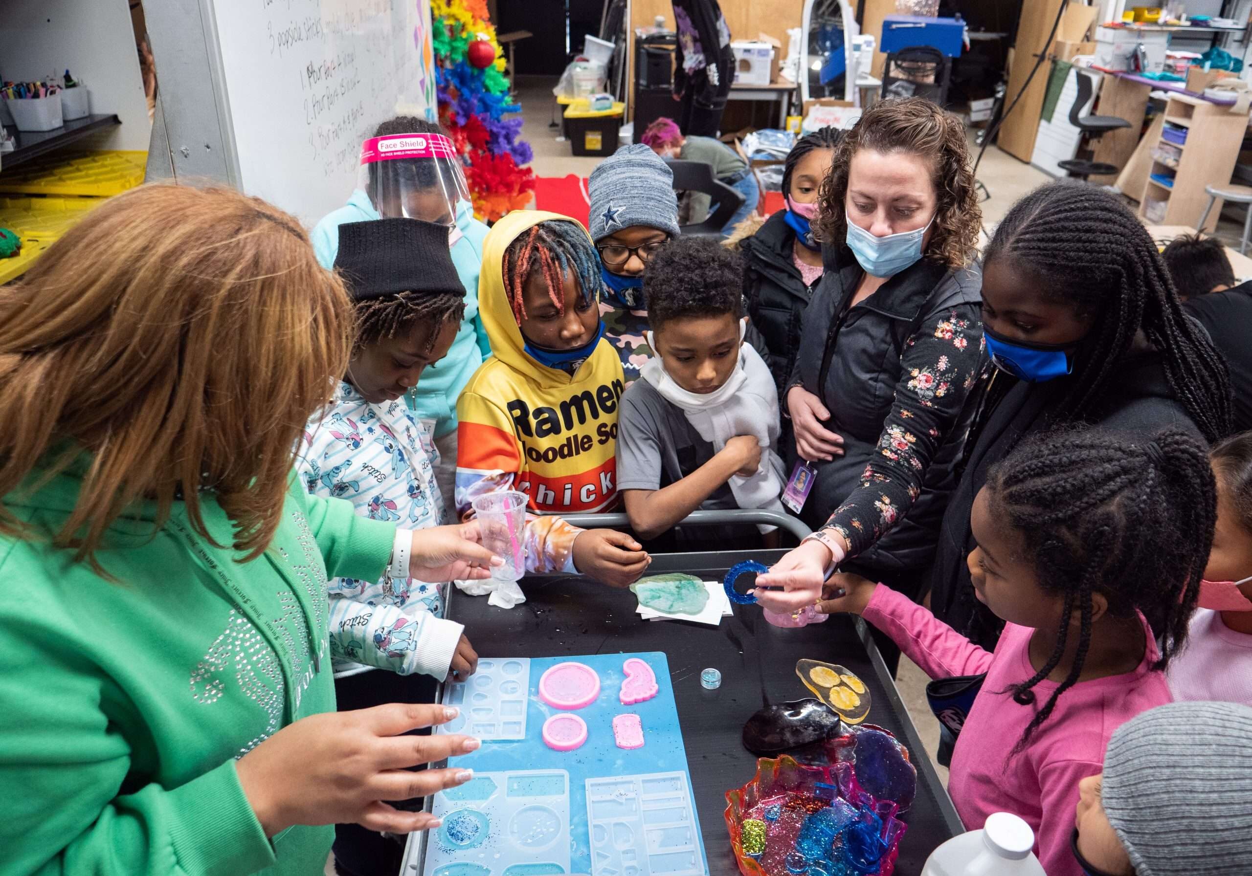 students and teacher using resin